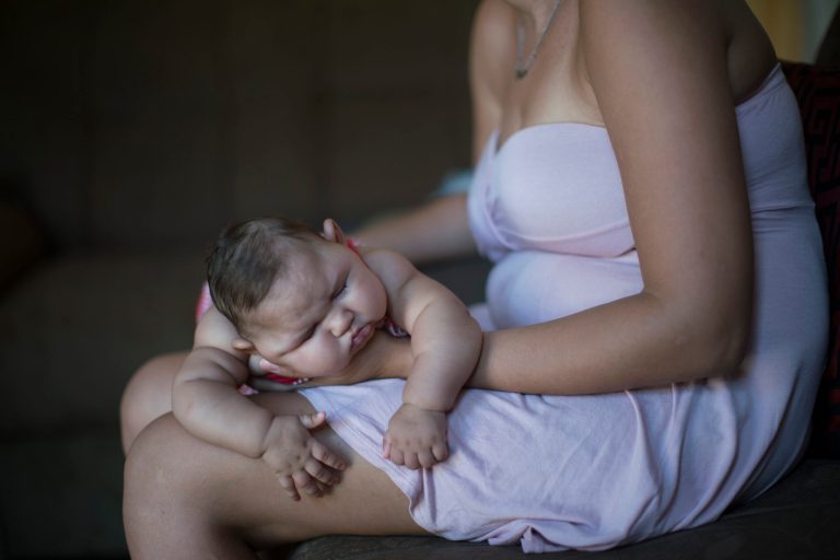 Gleyse Kelly da Silva holds her daughter Maria Giovanna as she sleeps in their house in Recife, Brazil, a focal point in the fight against the Zika virus. (AP Photo/Felipe Dana)