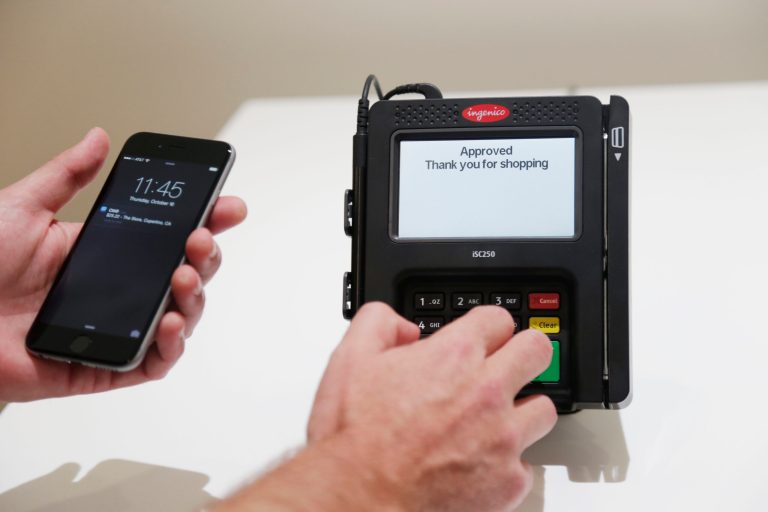 Apple Pay is demonstrated at Apple headquarters on Thursday, Oct. 16, 2014 in Cupertino, Calif. In announcing a Monday launch date, Apple CEO Tim Cook said deals have been made with hundreds of additional banks since the service was announced last month. Cook also said additional merchants plan to accept Apple Pay by the end of the year. (AP Photo/Marcio Jose Sanchez)