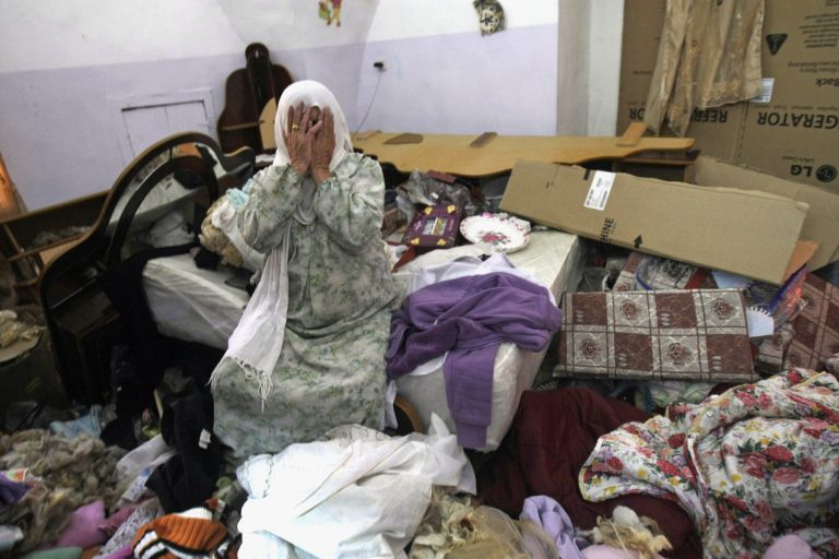 A Palestinian woman cries in her home after a raid by Israeli troops as the army continues feverish searches for three missing Israeli teens, in Salim village near the West Bank city of Nablus, Sunday, June 22,2014. Israel's military says troops have shot dead one Palestinian, and a Palestinian medical official says another was killed, as the army searches for three missing teens and looks to dismantle the Islamic militant group Hamas. Over the past week, thousands of Israeli troops have searched hundreds of locations in the West Bank and arrested more than 300 Palestinians, many from Hamas. (AP Photo/Nasser Ishtayeh)