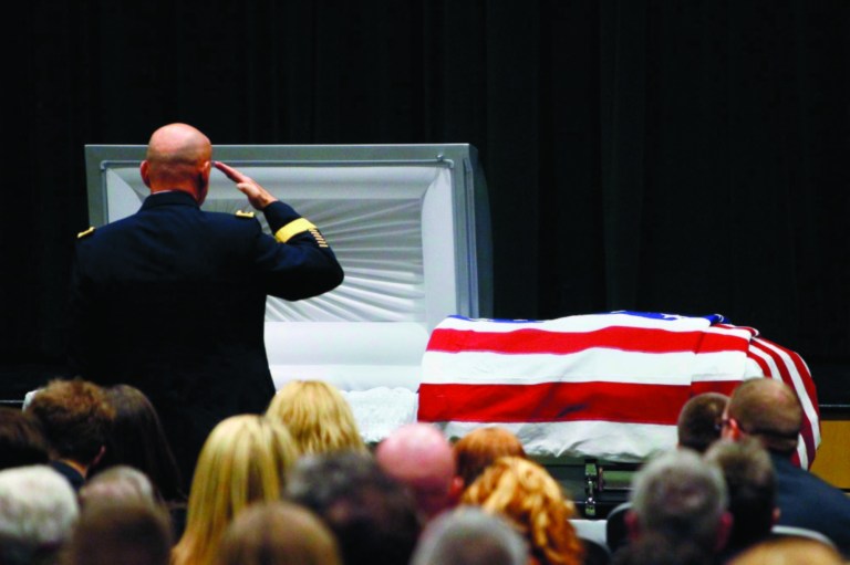 FILE - In this Saturday, March 3, 2012 file photo, Maj. Gen. David Quantock salutes Army Sgt. Timothy John Conrad, 22, who was killed in Afghanistan last week, at Conrad's funeral at Northside High School's auditorium in Roanoke, Va.. The 22-year-old Conrad was one of two U.S. military police officers killed Feb. 23 by an Afghan soldier amid anti-American sentiment over the burning of Qurans at a U.S. military base. The Afghan government is blaming the onslaught of attacks by Afghan police and soldiers against international forces on 