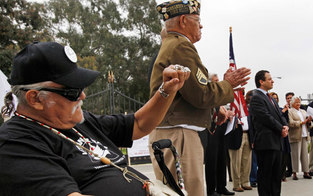 Groups representing U.S. military veterans say they worry that a new Department of Veterans Affairs plan to close out a massive backlog of unfinished disability benefits claims may be a bureaucratic dodge. In the photo above, veterans applaud during a 2011 news conference announcing a lawsuit against the department in Los Angeles. (AP Photo)
