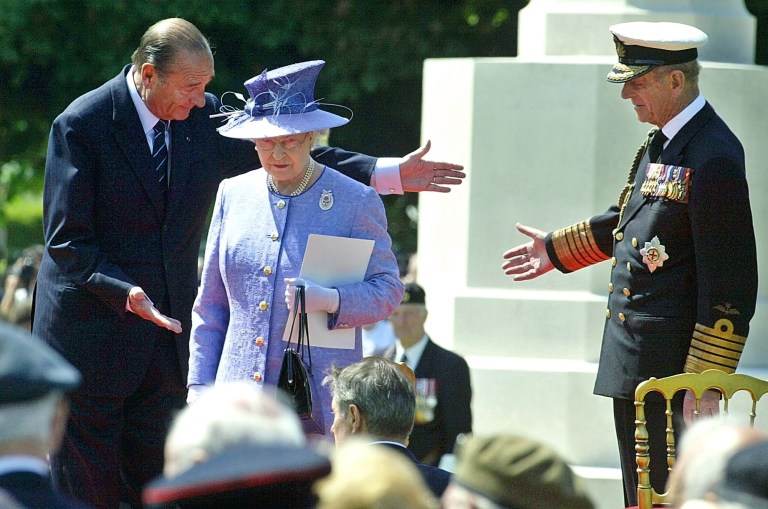 FILE - In this June 6, 2004 file photo, French President Jacques Chirac, left, greets Queen Elizabeth II, of Britain, and her husband Prince Philip at the British military cemetery in Bayeux, northwestern France, during ceremonies marking the 60th anniversary of the D-Day landings in Normandy. The perils of World War II directly shaped the lives of Elizabeth, 88, and Philip, 92. The anniversary is so heartfelt that the royal couple is preparing to cross the English Channel once more, this time on a Eurostar train through the Channel Tunnel Elizabeth helped 20 years ago. (AP Photo/Michel Spingler, File)