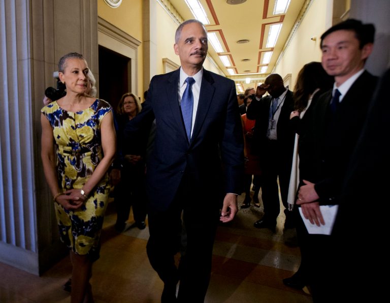 Attorney General Eric Holder, center, walks with his wife Sharon Malone, left, as he leaves his office for six years to a farewell gathering at the Justice Department in Washington, Friday, April 24, 2015. An office in his department that oversees the Freedom of Information Act throughout the executive branch failed a recent test of its compliance with the open government law.Â (AP Photo/Manuel Balce Ceneta)