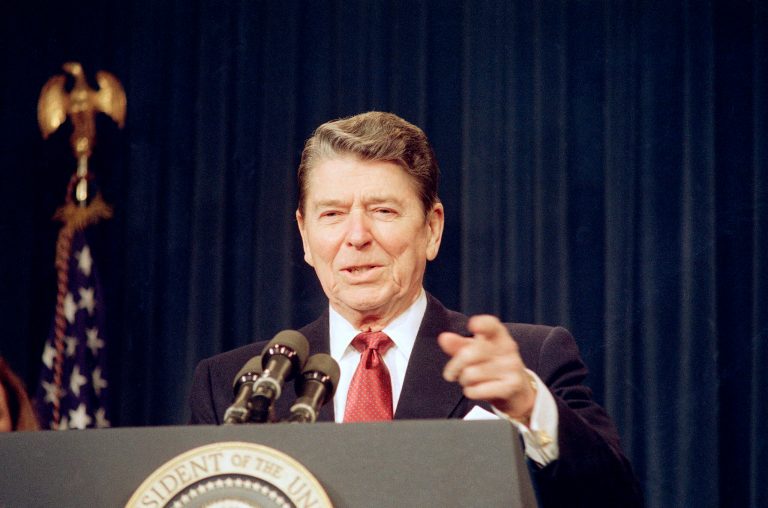 President Ronald Reagan gestures while addressing federal executives during a ceremony at the White House in Washington on Tuesday, Jan. 5, 1988. (AP/Barry Thumma)