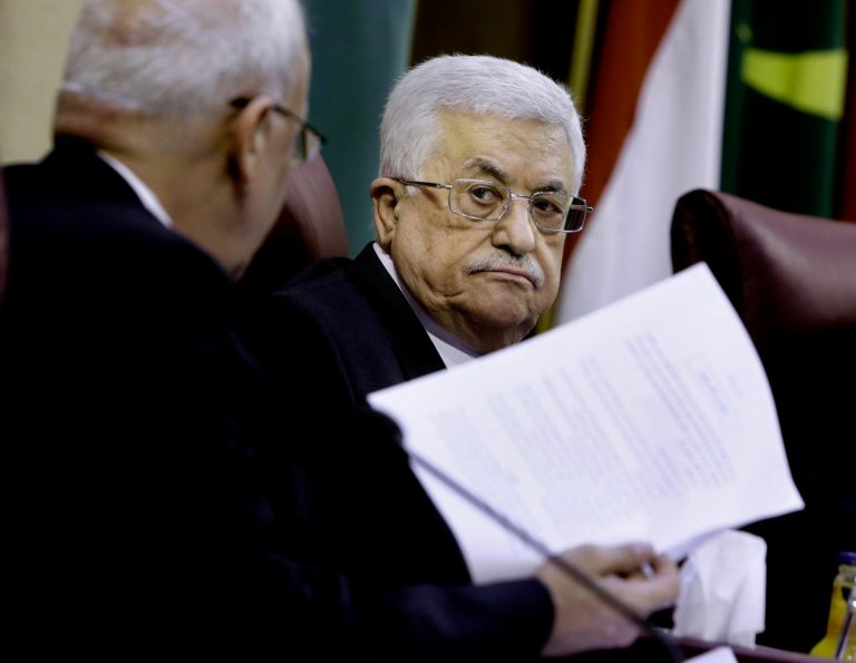 Palestinian President Mahmoud Abbas, right, listens to his chief negotiator Saeb Erekat during a meeting with Arab foreign ministers requested by Abbas at the League's headquarters in Cairo, Egypt, Wednesday, April 9, 2014. (AP Photo/Amr Nabil)