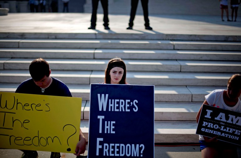 Rachel Del Guidici, 18, of Shreve, Ohio, and others, demonstrate against President Barack Obama's health care law outside the Supreme Court in Washington, Thursday, June 28, 2012. (AP Photo/David Goldman)