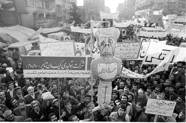 An effigy of President Carter is held aloft during a mass demonstration as thousands of factory workers show their support for the students holding hostages inside the U.S. Embassy in Tehran, Dec. 23, 1979. (AP Photo/Jacques Langevin)
