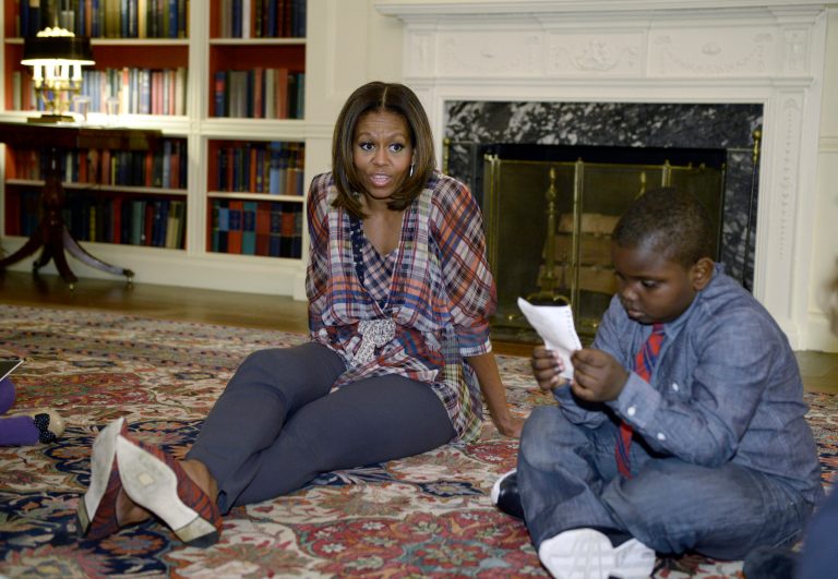 First lady Michelle Obama sits on the floor with 