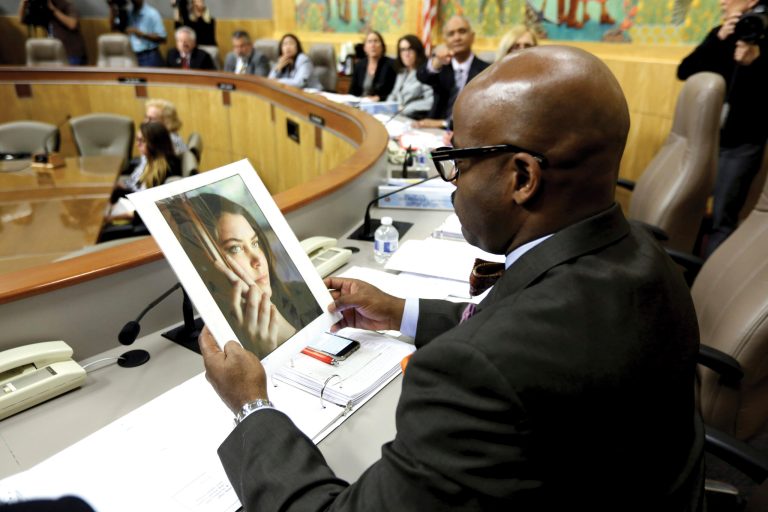 State Sen. Isadore Hall, D-Compton, a member of the Senate Health Committee looks at a photo of Brittany Maynard as lawmakers took testimony on proposed legislation allowing doctors to prescribe life ending medication to terminally ill patients. (AP Photo/Rich Pedroncelli)