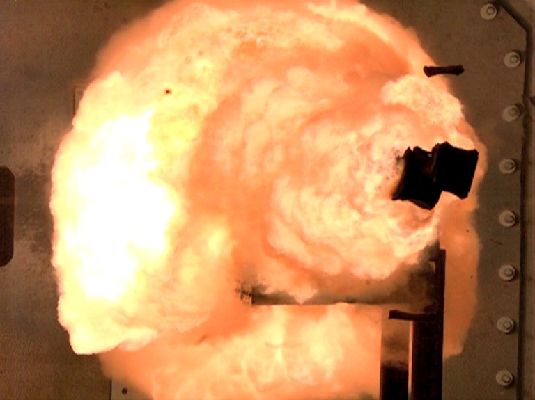 A high-speed camera captures the first full-energy shots from an electromagnetic launcher at a test facility in Dahlgren, Va. (AP Photo/U.S. Navy, John F. Williams)