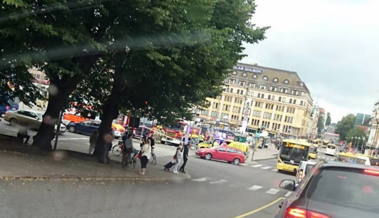 Turku Market Square on Friday, Aug. 18, 2017, with a yellow ambulance on the corner of the square (behind red car). Police in Finland say they have shot a man in the leg after he was suspected of stabbing several people in the western city of Turku. (Lehtikuva via AP)