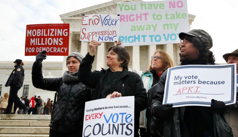 People rally outside of the Supreme Court in opposition to Ohio's voter roll purges. (AP Photo/Jacquelyn Martin)