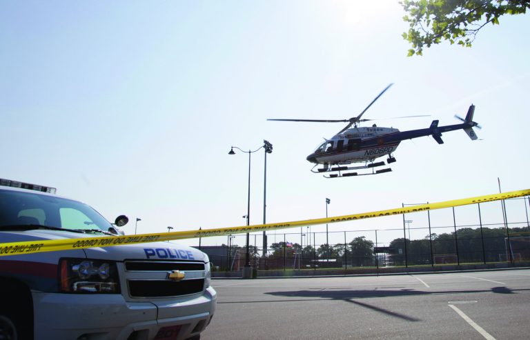 A police helicopter takes off from the scene of a news conference as part of an investigation into a fatal boating accident in Oyster Bay, N.Y., Thursday, July 5, 2012. Police say three bodies pulled out of New York's Long Island Sound after a yacht capsized on the Fourth of July were all children. The bodies of the 12-year-old boy and two girls, ages 11 and 8, were recovered from the boat's cabin. Twenty-four other people were rescued, and were treated and released. (AP Photo/Seth Wenig)