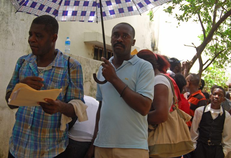 In this Aug. 26, 2014 photo, people line up to apply for Haitian identity cards at an office recently opened in Santo Domingo, Dominican Republic. The Dominican Republic is approving the first residency and work permits for migrants under a new program. To qualify for legal residency, migrants must have come to the Dominican Republic before October 2011. Migrants and advocates say the required documentation is hard to come up with and many may not make it by the May 31 deadline. (AP Photo/Ezequiel Abiu Lopez)