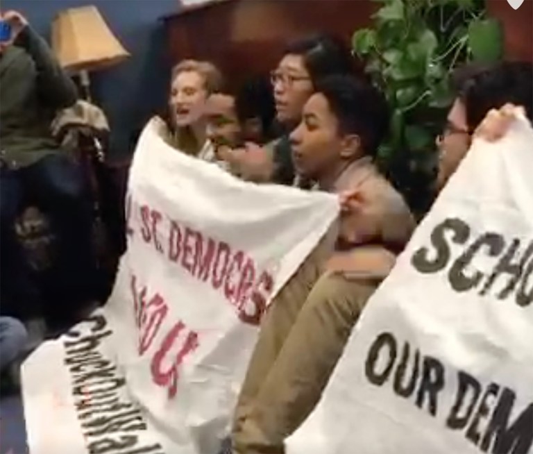 The goal of Monday's sit-in is to get Chuck Schumer to drop out of the race to replace Sen. Harry Reid as minority leader in favor of Sen. Bernie Sanders. (Screenshot via Periscope)