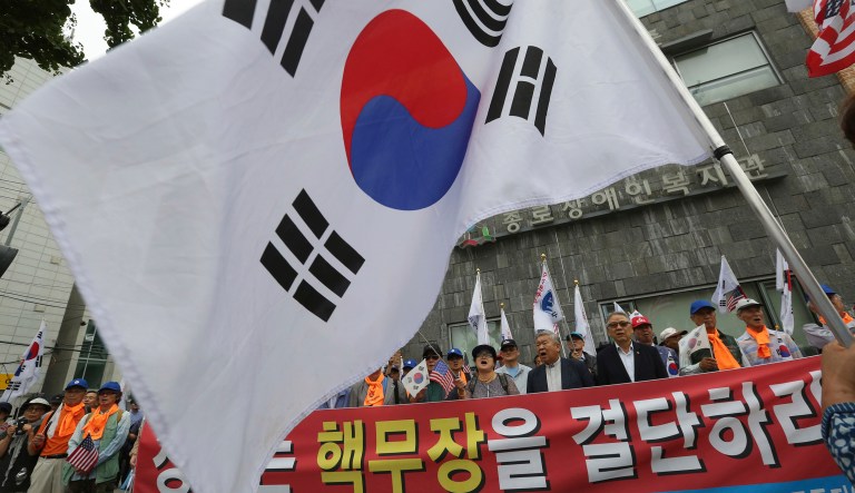 Protesters demand the deployment of nuclear weapons in South Korea, near the presidential Blue House in Seoul, South Korea, Tuesday, Sept. 5, 2017. South Korean warships have conducted live-fire exercises at sea. The drills Tuesday mark the second-straight day of military swagger from a nation still rattled by the North's biggest-ever nuclear test. The signs read 