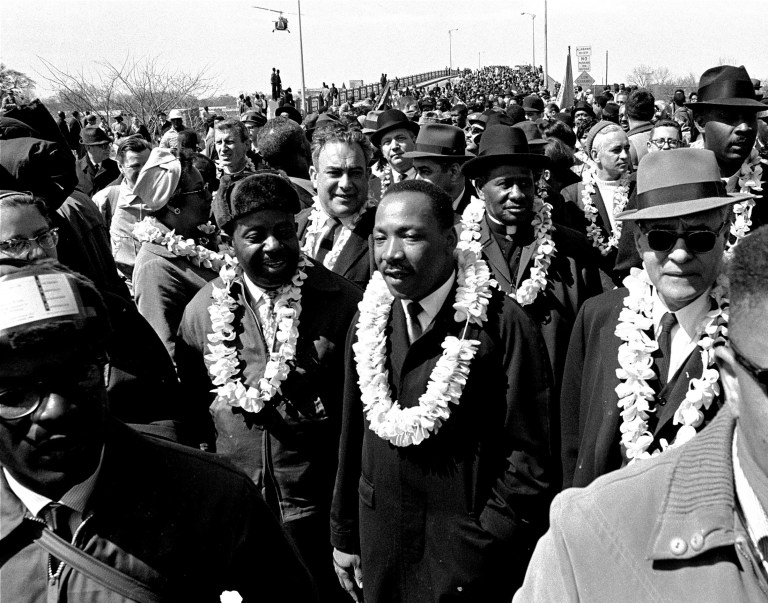 In this March 21, 1965 file photo, Martin Luther King, Jr. and his civil rights marchers cross the Edmund Pettus Bridge in Selma, Ala., heading for capitol, Montgomery, during a five day, 50 mile walk to protest voting laws. (AP Photo/File)