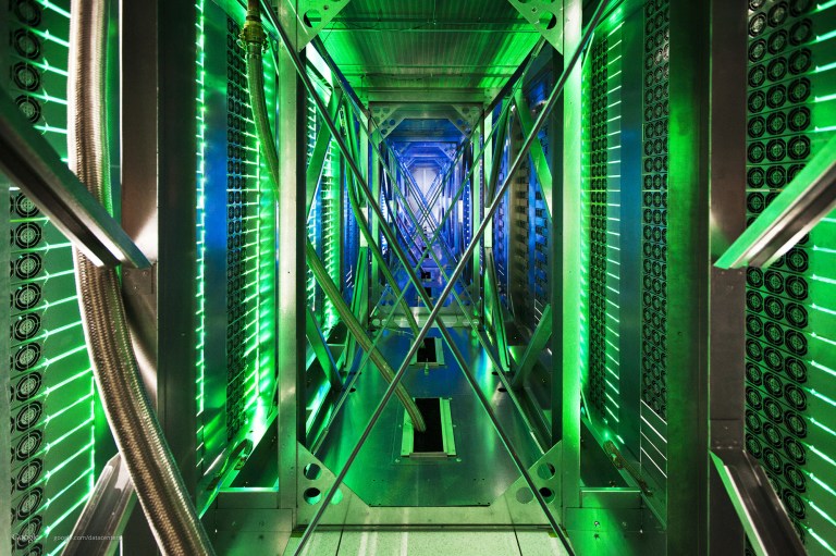 FILE - In this undated file photo made available by Google, hundreds of fans funnel hot air from the computer servers into a cooling unit to be recirculated at a Google data center in Mayes County, Okla. The green lights are the server status LEDs reflecting from the front of the servers. Eight major technology companies, including Google, Facebook and Twitter, have joined forces to call for tighter controls on government surveillance, issuing an open letter Monday, Dec. 9, 2013 to President Barack Obama arguing for reforms in the way the U.S. snoops on people. (AP File)
