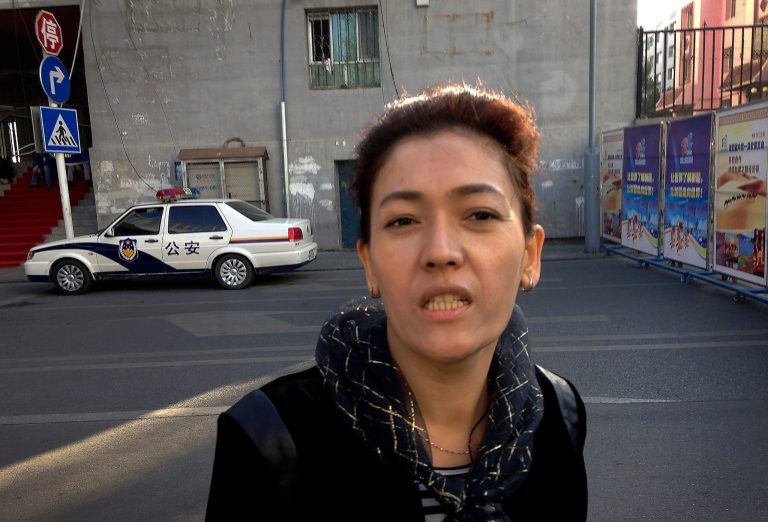 Guzulnur, wife of Ilham Tohti arrives at Urumqi People's Intermediate Court to attend her husband's trial in Urumqi, China's northwestern region of Xinjiang Thursday, Sept. 18, 2014. The defense in the separatism trial of Tohti, a Muslim Uighur scholar, sought to show Thursday that his classroom lectures and online commentary never amounted to a campaign to split his native region of Xinjiang away from China. (AP Photo/Jack Chang)