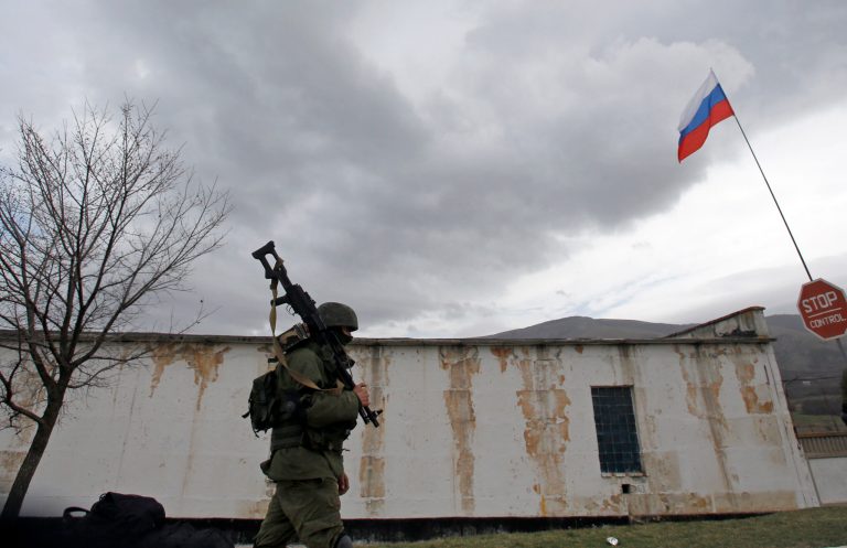 A Russian soldier marches as he and comrades block the Ukrainian infantry base in Perevalne,ÃÂ Ukraine, on Tuesday. (AP/Darko Vojinovic)