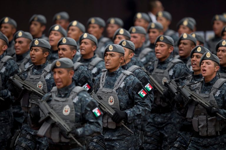 Officers belonging to Mexico's newest police force, known as the gendarmerie, march during the launching ceremony for the new force at the Federal Police headquarters in Mexico City, Friday, Aug. 22, 2014. Gendarmerie members will be a division of the federal police and will be sent to protect areas like those where wheat and sorghum farmers, banana growers and mining firms have been hit by organized crime. (AP Photo/Eduardo Verdugo)