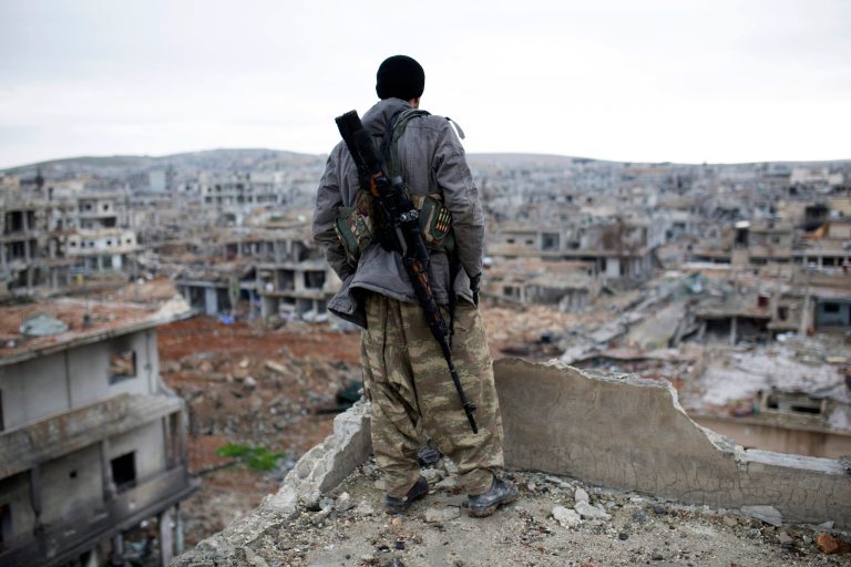 In this Jan. 30, 2015, file photo, a Syrian Kurdish sniper looks at the rubble in the Syrian city of Ain al-Arab, also known as Kobani. According to NBC News, U.S. citizenÂ Keith Broomfield, whoÂ joined the Kurdish fighters voluntarily,Â died in a battle in a rural area outside of KobaniÂ (AP Photo, File)