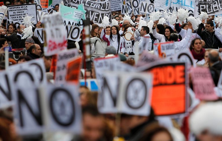   Protestors march as they hold banners reading, 'No financial cuts' during a demonstration against regional government-imposed austerity plans to restructure and part-privatize health care sector in Madrid, Spain, Sunday, Dec. 16, 2012. Madrid proposes selling off the management of six of 20 public hospitals and 27 of 268 health centers. Spain's regions are struggling with a combined debt of â¬145 billion ($190 billion) as the country's economy contracts into a double-dip recession triggered by a 2008 real estate crash. (AP Photo/Andres Kudacki)  