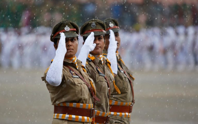Indian policewomen salute as they march in the rain during a parade to mark Independence Day in Jammu, India, Friday, Aug. 15, 2014. India celebrates its 1947 independence from British colonial rule on Aug. 15. (AP Photo/Channi Anand)