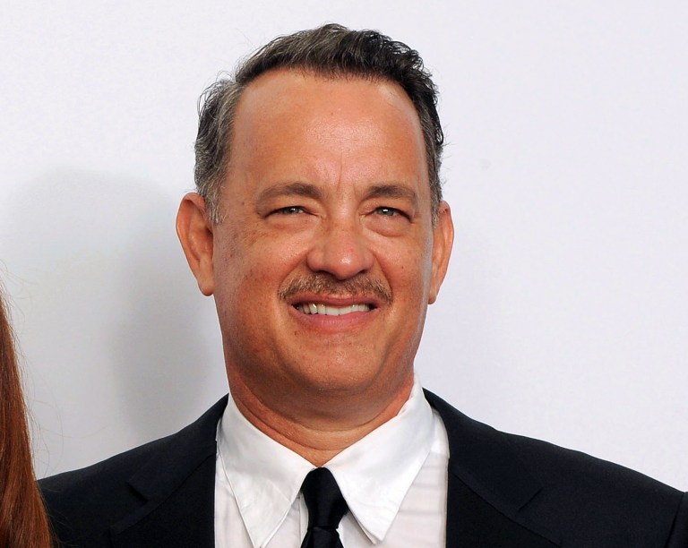   FILE - This Sept. 23, 2012 file photo shows Tom Hanks backstage at the 64th Primetime Emmy Awards at the Nokia Theatre in Los Angeles. Hanks' Broadway debut will include an old buddy _ former âBosom Buddiesâ co-star Peter Scolari will share the stage with the Oscar winner. Producers revealed the rest of the cast to appear with Hanks in Nora Ephron's play 
