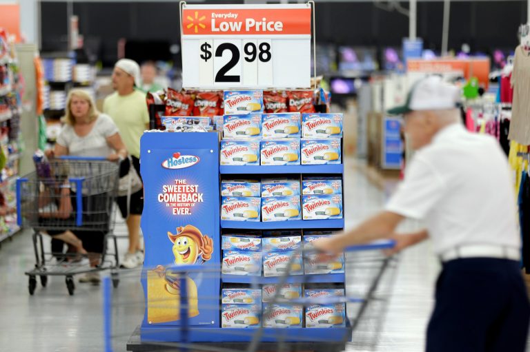   FILE - In this Friday, July 12, 2013, file photo, customers shop at a Wal-Mart, in Bristol, Pa. The Federal Reserve reports how much consumers borrowed in July on Monday, Sept. 9, 2013. (AP Photo/Matt Rourke, File)  