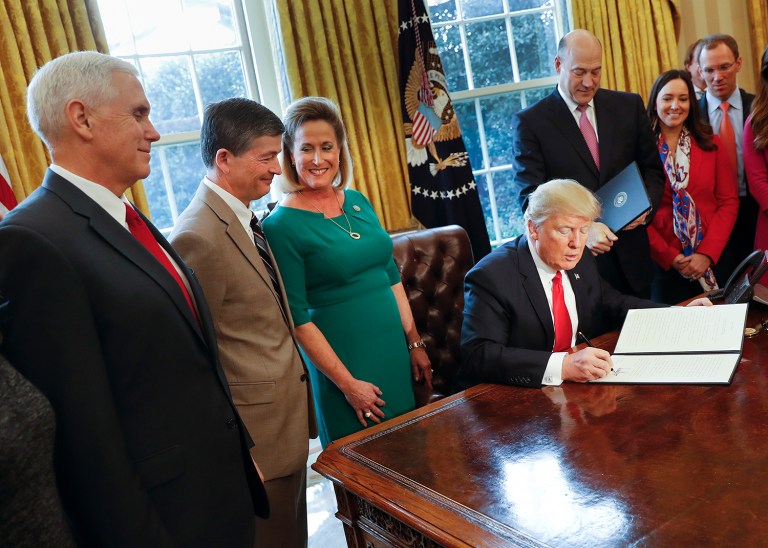 President Donald Trump signs an executive order in the Oval Office of the White House in Washington on Feb. 3. Trump signed an executive order that will direct the Treasury secretary to review the 2010 Dodd-Frank financial oversight law, which reshaped financial regulation after 2008-2009 crisis. From left are, Vice President Mike Pence Rep. Jeb Hensarling, R-Texas, Rep. Ann Wagner, R Mo. and National Economic Council Chairman Gary Cohn. (AP Photo/Pablo Martinez Monsivais)