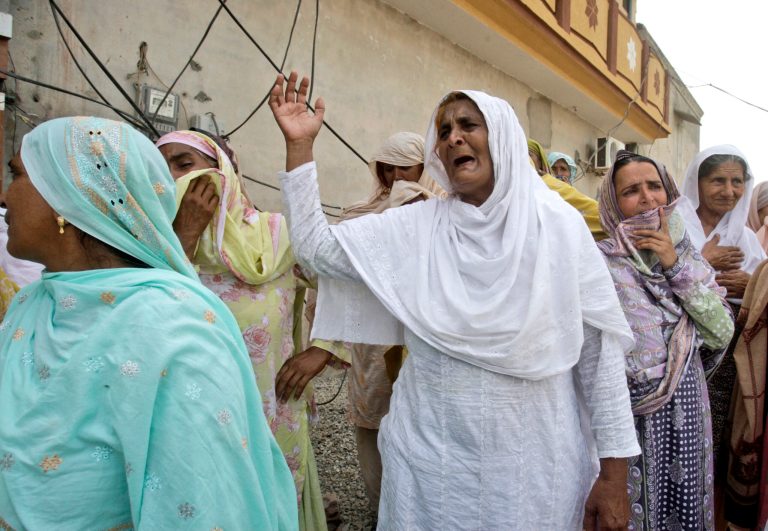 Pakistani women mourn the death of their relatives, who were killed in gas cylinder explosion on a minibus, in Gujrat, Pakistan, Saturday, May 25, 2013. Police say that a teacher was among more than a dozen people burned to death in eastern Pakistan when a minibus taking children to school suddenly caught fire. (AP Photo/K.M. Chaudary)