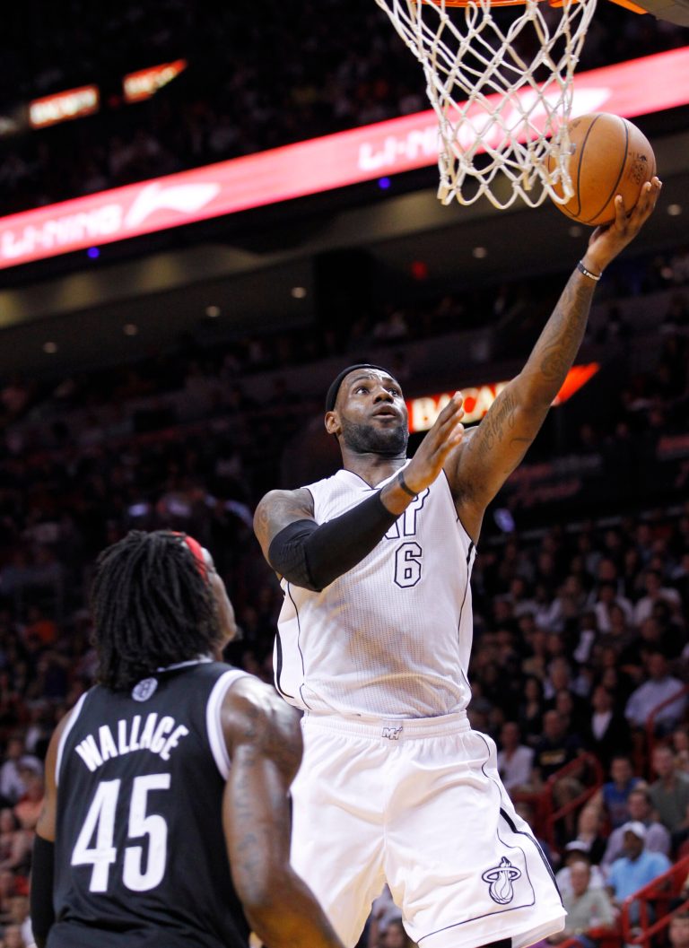   Miami Heat forward LeBron James (6) goes up for a shot against Brooklyn Nets forward Gerald Wallace (45) during the first half of an NBA basketball game, Saturday, Dec. 1, 2012 in Miami. (AP Photo/Wilfredo Lee)  
