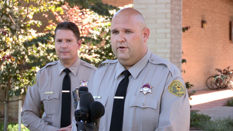 Santa Clarita Valley Sheriffâs Station deputy Joshua Dubin announces the arrest of a 15-year-old boy Sunday, Aug. 17, 2014, on suspicion of posting online threats to shoot students at Southern California schools in Valencia, Calif. Deputies arrested the teen after serving a search warrant at his home, Lt. Tom Bryski said. (AP Photo/The Santa Clarita Valley Signal, Austin Dave)