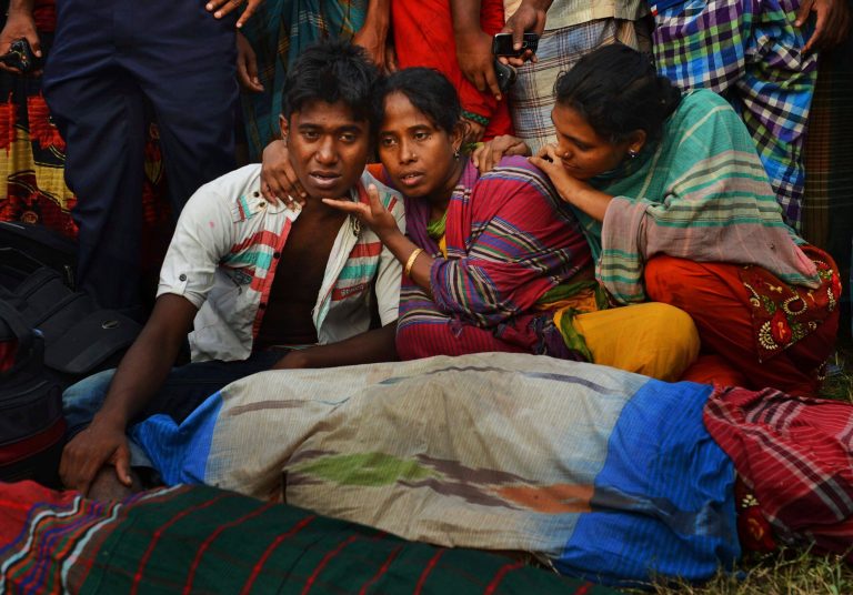 Unidentified Bangladeshi relatives wail near bodies of victims on the banks of the River Meghna after a ferry carrying more than 100 passengers capsized and sank after being hit by a storm in Munshiganj district, Bangladesh, Thursday, May 15, 2014. According to an official eight bodies have been recovered and there was confusion about the number of missing people. (AP Photo/Sony Ramany)