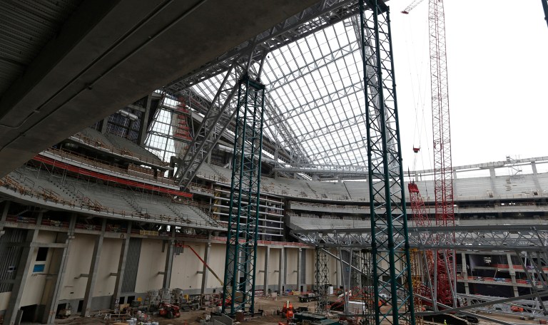 Although the federal government doesn't directly subsidize stadium construction, it loses revenue when stadiums are financed with tax-exempt municipal bonds because the interest income that bond-buyers earn is tax-free at the federal level. Above, os are lightweight EFTE roof panels on July 16, 2015 at the construction site of the Minnesota Vikings NFL football stadium. (AP Photo/Jim Mone)