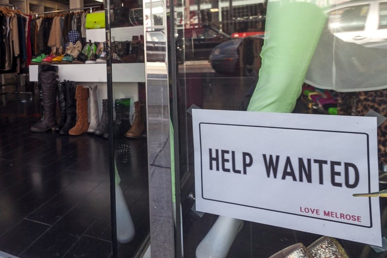In this  Friday, Dec. 7, 2012, photo, a help wanted sign is posted on the front window of a clothing boutique in Los Angeles.  (AP File)