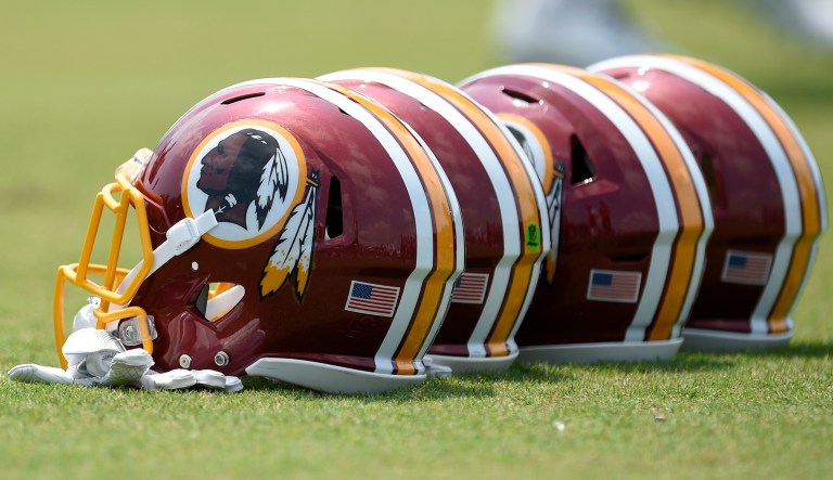 Washington Redskins football helmets sit on the field during an NFL football team practice, Wednesday, June 14, 2017, in Ashburn, Va. (AP Photo/Nick Wass)
