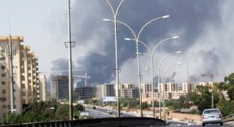 FILE - In this Sunday, July 13, 2014 file image made from video by The Associated Press, smoke rises from the direction of Tripoli airport in Tripoli, Libya. The United States shut down its embassy in Libya on Saturday, July 26, 2014, and evacuated its diplomats to neighboring Tunisia under U.S. military escort amid a significant deterioration in security in Tripoli as fighting intensified between rival militias, the State Department said.  (AP Photo/File)