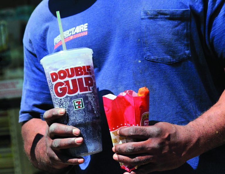 FILE - In this May 31, 2012 file photo, a man leaves a 7-Eleven store with a Double Gulp drink, in New York. Opponents of the city's limit on the size of sugary drinks are are raising questions of racial fairness alongside other complaints as the novel restriction faces a court test. (AP Photo/Richard Drew, File)
