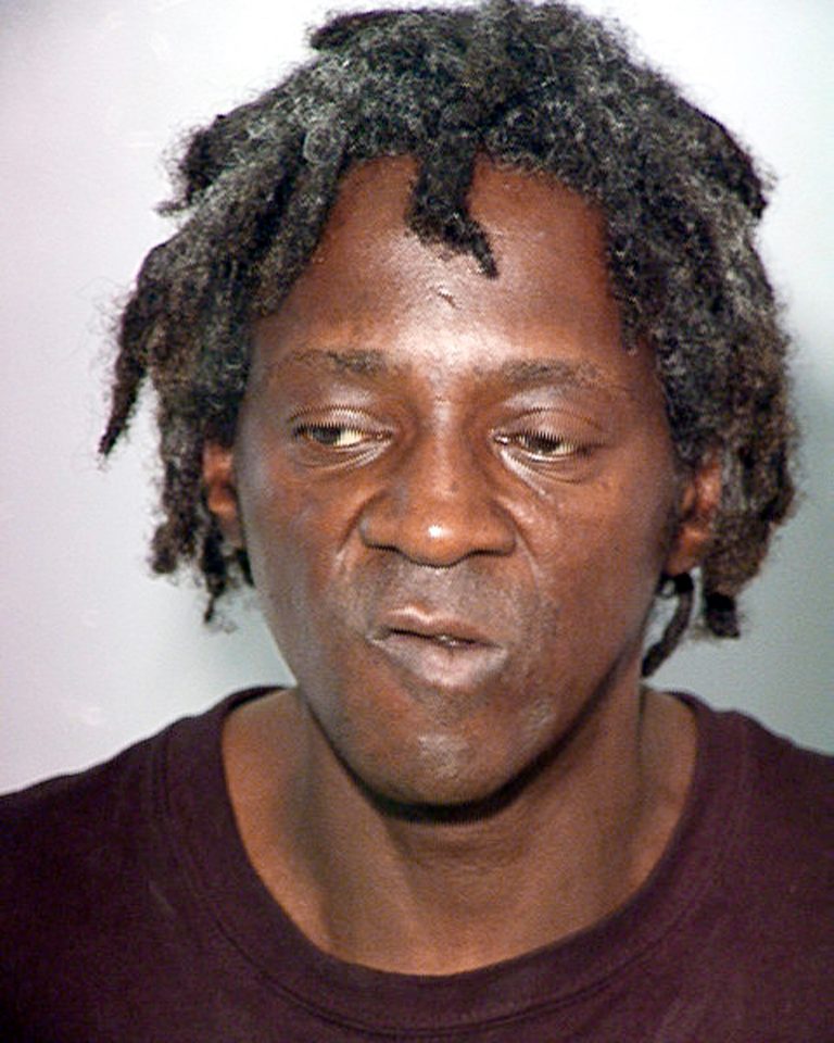 File - This Oct. 17, 2012 file image released by the Las Vegas Police Department shows rapper Flavor Flav, also known as William Jonathan Drayton, Jr., in a police booking photo. Entertainer FlavorÃFlav is expected to plead not guilty in Nevada state court to felony charges alleging he chased and threatened his longtime girlfriend's 17-year-old son with a butcher knife during a family argument last October. (AP Photo/Las Vegas Police Department, file)