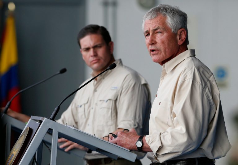 U.S. Defense Secretary Chuck Hagel, right, speaks at a press conference at the Tolemaida military base, in Melgar, Colombia, Friday, Oct. 10, 2014. Hagel is on a six-day, three-country trip to South America. Hagel will also travel to Chile and Peru, where he will attend a conference of defense ministers from the Americas. Pictured left is  Colombia's Defense Minister Juan Carlos Pinzon. (AP Photo/Fernando Vergara)