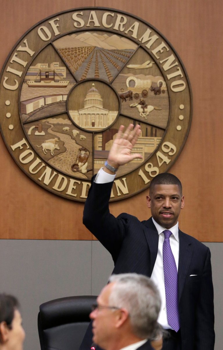 Sacramento Mayor Kevin Johnson waves to Vivek Ranadive, majority owner of the Sacramento Kings after the Sacramento City Council approved a financing plan for a new arena for the NBA basketball team, in  Sacramento, Calif., Tuesday, May 20, 2014.  The council voted 7-2 on the package that clears the way for construction of a $477 million downtown arena.(AP Photo/Rich Pedroncelli)
