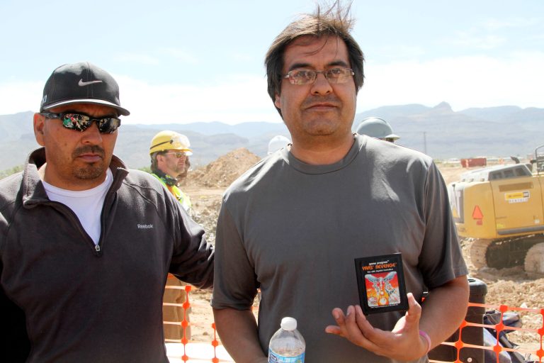 FILE - In this April 26, 2014 file photo,left, and Raul Ruiz pose for a photograph with a cartridge they found buried in a landfill in Alamogordo, N.M. Producers of a documentary dug in an southeastern New Mexico landfill in search of millions of cartridges of the Atari 'E.T. the Extra-Terrestrial' game that has been called the worst game in the history of video gaming and were buried there in 1983.  Officials in  Alamogordo, are working on a plan under which film companies, museums and the public could get Atari video games that were dug up from the old landfill last month. (AP Photo/Juan Carlos Llorca)