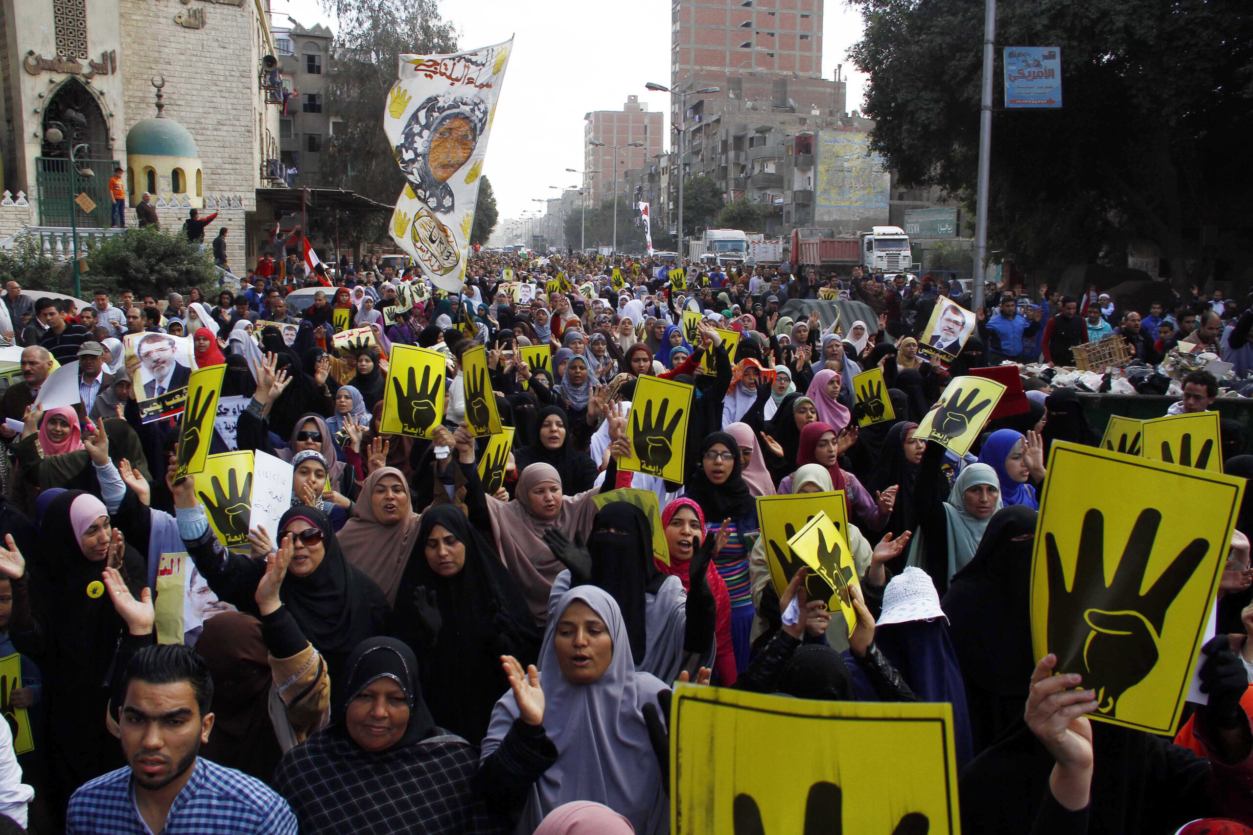 Ousted Egypt leader’s lawyers protest court cage