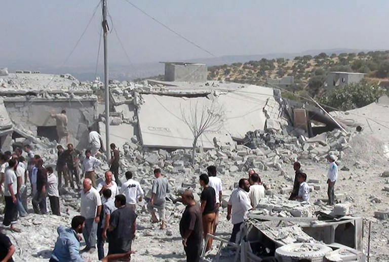 In this citizen journalism image provided by Edlib News Network, ENN, which has been authenticated based on its contents and other AP reporting, Syrians search under rubble to rescue people from houses that were destroyed by a Syrian government warplane, in Idlib province, northern Syria, Friday, Aug. 30, 2013. United Nations experts are investigating the alleged use of chemical weapons in Syria as the United States and its allies prepare for the possibility of a punitive strike against President Bashar Assad's regime, blamed by the Syrian opposition for the attack. The international aid group Doctors Without Borders says at least 355 people were killed in the Aug. 21 attack in a suburb of Damascus, the Syrian capital. (AP Photo/Edlib News Network ENN)