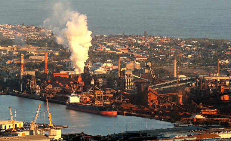 FILE - In this July 2, 2014 file photo, smoke billows out of a chimney stack of steel works factories in Port Kembla, south of Sydney. Australia's government repealed a much-maligned carbon tax on the nation's worst greenhouse gas polluters on Thursday, July 17, 2014, ending years of contention over a measure that became political poison for the lawmakers who imposed it. The Senate voted 39 to 32 to axe the 24.15 Australian dollar ($22.60) tax per metric ton of carbon dioxide that was introduced by the center-left Labor government in July 2012. (AP Photo/Rob Griffith, File)