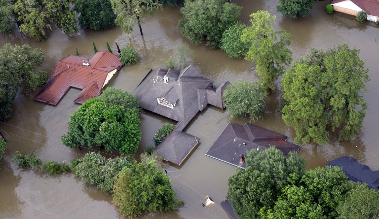 Homes are surrounded by floodwaters from Tropical Storm Harvey Tuesday in Spring, Texas. Houston and parts of Southeastern Texas were hit with record-setting rainfall after Hurricane Harvey made landfall over the weekend, forcing thousands to leave their homes due to catastrophic flooding. (AP Photo/David J. Phillip)