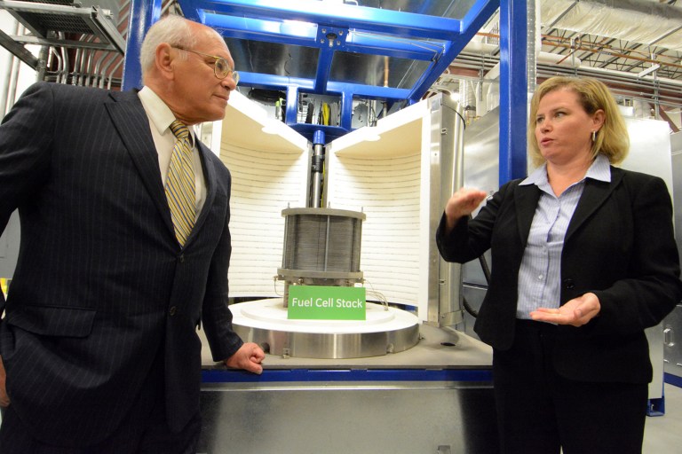 Joanna Wellington, general manager of GE Fuel Cells, explains the use of fuel cell stacking ovens with Congressman Paul Tonko on Tuesday, Aug. 26, 2014 in Schenectady, N.Y. Wellington announced on Tuesday that General Electric Co. is opening a new facility devoted to the development of fuel cells in Malta, N.Y. The company says it has reached a deal with Hudson Valley Community College to install and operate a smaller, 50 kilowatt fuel cell generator. Hudson Valley college officials say the deal will open the door to new career fields for the students. (AP Photo/The Daily Gazette, Marc Schultz)  TROY, SCHENECTADY; SARATOGA SPRINGS; ALBANY AND AMSTERDAM OUT