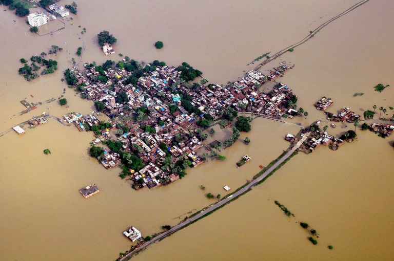 This Sunday, Aug. 17, 2014 aerial photo shows houses in a residential area partially submerged by monsoon floods at Nalanda district of Bihar, India. Rescue and relief operations continue in the state of Bihar after heavy rains caused landslides and floods in many parts of India. (AP Photo/Press Trust of India) INDIA OUT